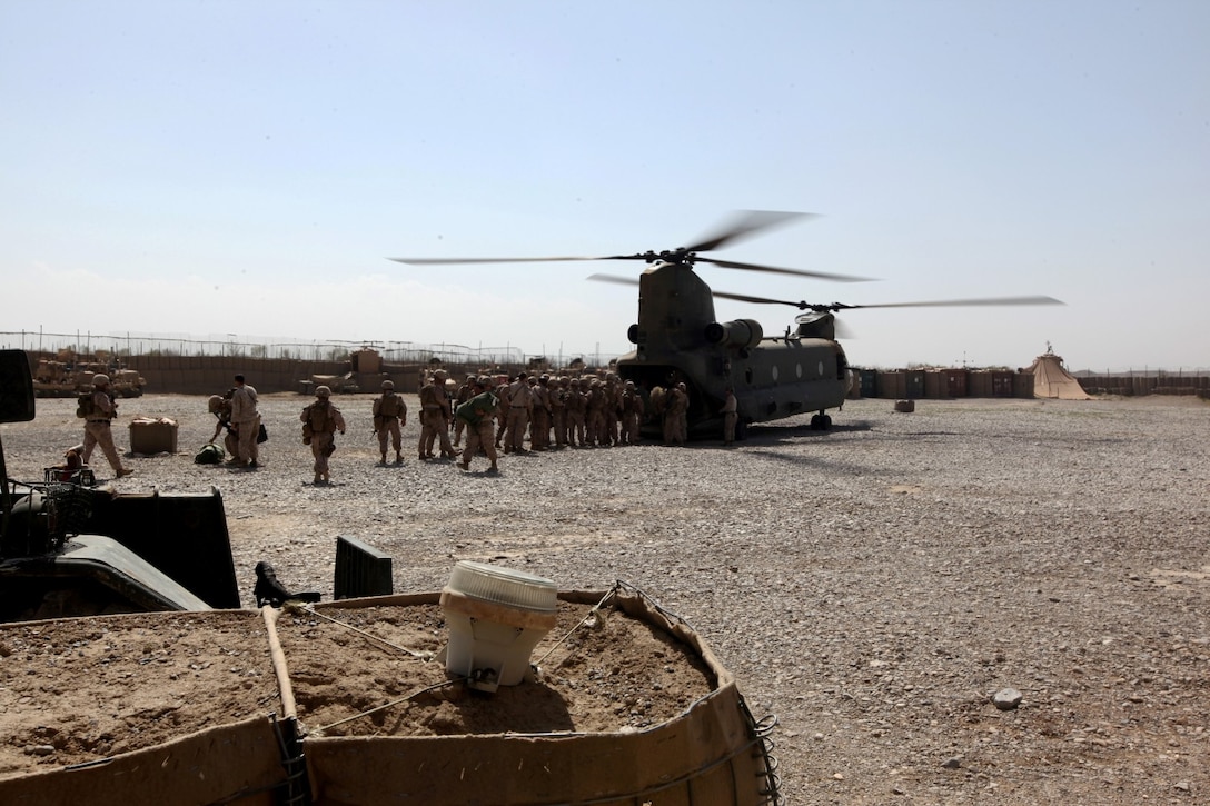 Marines of Charlie Company, 1st Battalion, 7th Marine Regiment, unload their packs and gear aboard Forward Operating Base Sabit Qadam, Helmand province, Afghanistan, March 8, 2014. The Marines are relieving 3rd Bn., 7th Marines on the FOB and will be some of the final Marines in Sangin Valley.