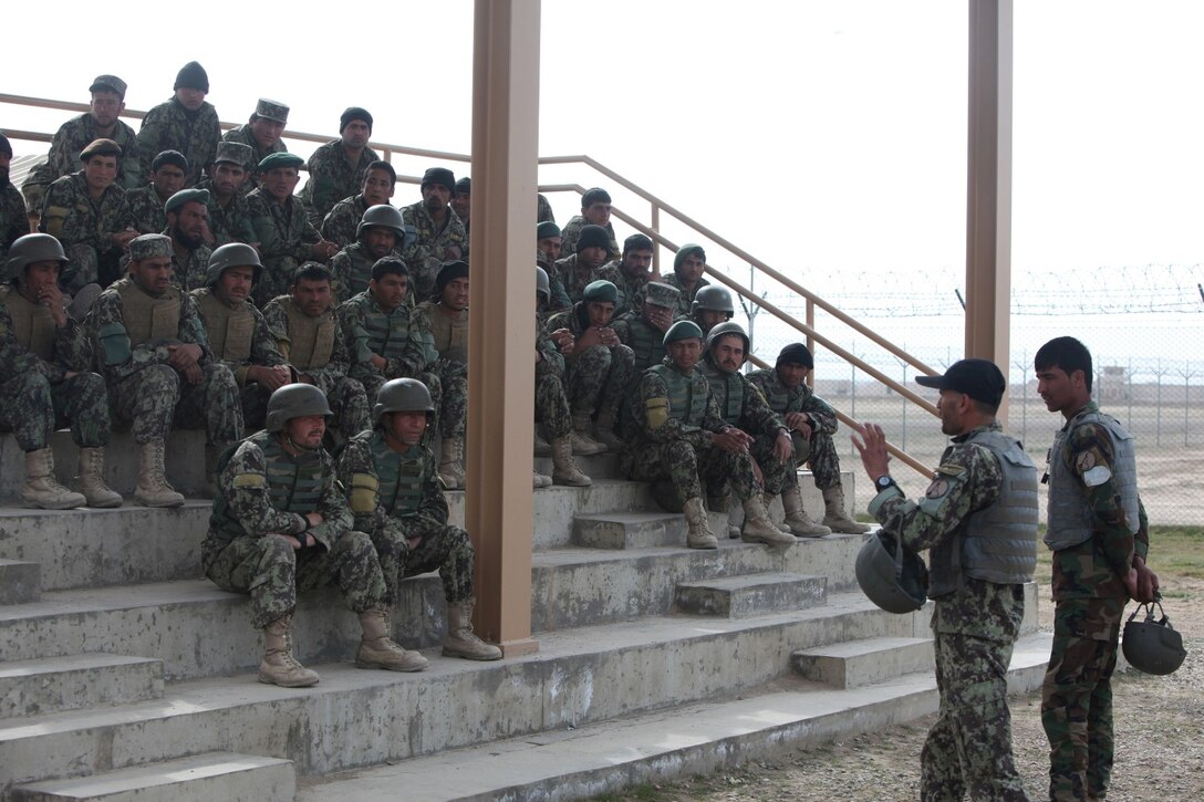 Sergeant Ahmaduuah, bottom left, a mortar instructor with Regional Corps Battle School, 7th Kandak, 215th Corps, Afghan National Army, instructs students before a live-fire training exercise that marked the conclusion of a four-week mortarman's course aboard Camp Shorabak, Afghanistan, Mar. 5, 2014. The course instilled basic mortarman skills as well as taught explosive ordnance disposal skills to approximately 40 ANA soldiers. The ANA soldiers newly acquired training will give them an advantage on the battlefield as they return to their units throughout Afghanistan. (U.S. Marine Corps photo by Cpl. Cody Haas/ Released)