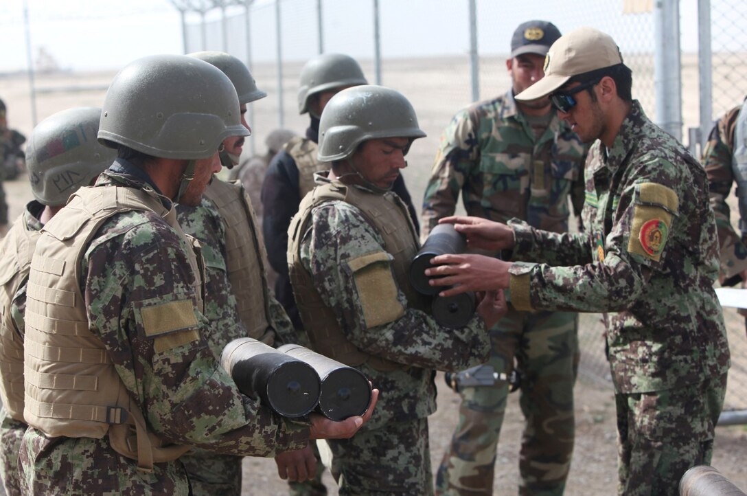 Soldiers with 7th Kandak, 215th Corps, Afghan National Army, acquire M37 82 mm mortar rounds for a live-fire training exercise that marked the conclusion of a four-week mortarman's course aboard Camp Shorabak, Afghanistan, Mar. 5, 2014. The course instilled basic mortarman skills as well as taught explosive ordnance disposal skills to approximately 40 ANA soldiers. The ANA soldiers newly acquired training will give them an advantage on the battlefield as they return to their units throughout Afghanistan. (U.S. Marine Corps photo by Cpl. Cody Haas/ Released)