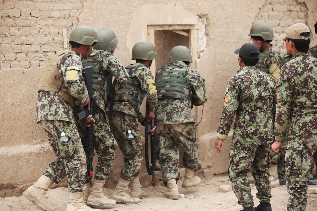 Soldiers with the 215th Corps, Afghan National Army, forcefully enter a simulated enemy-occupied compound during a Military Operations in Urban Terrain training exercise aboard Camp Bastion, Afghanistan, March 8, 2014. The exercise is part of the Regional Corps Battle School's four-week rifleman's course, which instills intermediate rifleman skills in ANA soldiers. The ANA soldiers' newly acquired training will give them an advantage on the battlefield as they return to their units throughout Afghanistan. (U.S. Marine Corps photo by Cpl. Cody Haas/ Released)