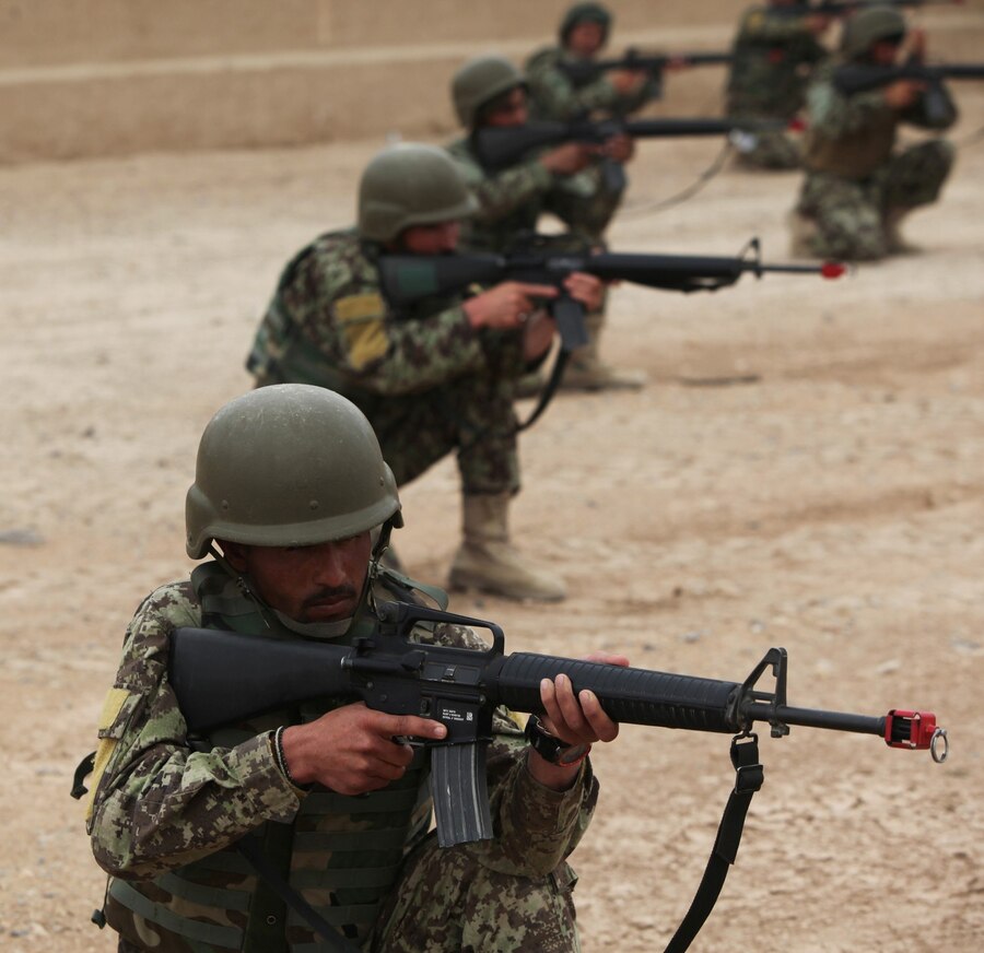 Soldiers with the 215th Corps, Afghan National Army, provide security during a Military Operations in Urban Terrain training exercise aboard Camp Bastion, Afghanistan, March 8, 2014. The exercise is part of the Regional Corps Battle School's four-week rifleman's course, which instills intermediate rifleman skills in ANA soldiers. The ANA soldiers' newly acquired training will give them an advantage on the battlefield as they return to their units throughout Afghanistan. (U.S. Marine Corps photo by Cpl. Cody Haas/ Released)
