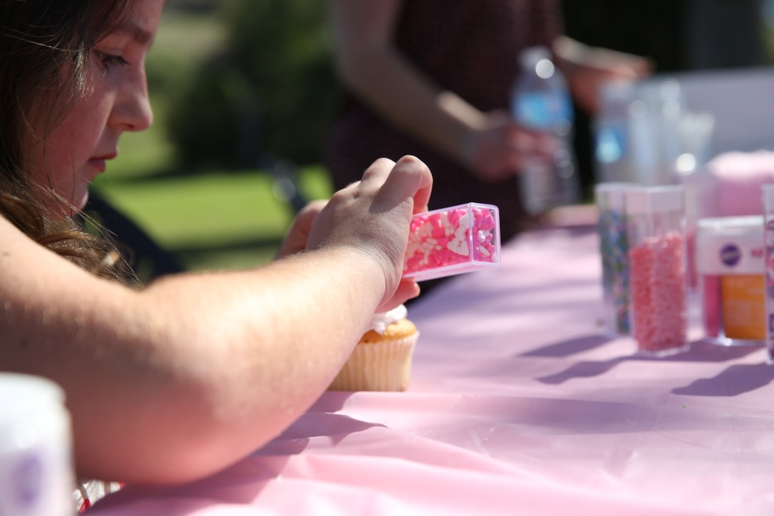 Rachel O'Brien, daughter of Gunnery Sgt. Peter O'Brien, Headquarters and Service Company gunnery sergeant, 3rd Battalion, 5th Marine Regiment, decorates her cupcake during a father/daughter luncheon aboard Marine Corps Base Camp Pendleton, Calif., March 9, 2014. The luncheon connected the Marines with their daughters and gave them a chance to meet other families in the battalion before they deploy to Okinawa, Japan in April. The event included several games, a cupcake decorating table and a large lunch.