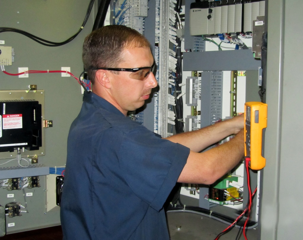 Josh Brown, an electrical trainee in the U.S. Army Corps of Engineers Hydropower Training Program, works on electrical equipment at the Richard B. Russell Dam.