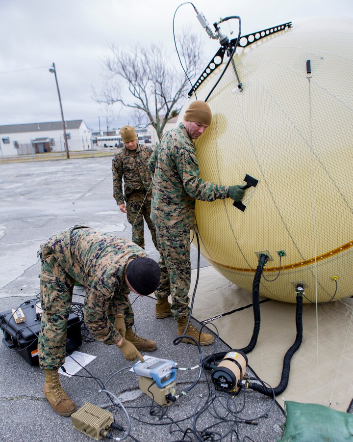 U.S. Marines assigned to the 26th Marine Expeditionary Unit (MEU) utilize a ground to air transmit and receive (GATR) inflatable satellite antenna (ISA) during a demonstration aboard Camp Lejeune, N.C., March 7, 2014. The 26th MEU communications and data Marines conducted the training and a proficiency examination to enhance their expeditionary readiness. (U.S. Marine Corps photo by Lance Cpl. Joshua W. Brown/Released) 