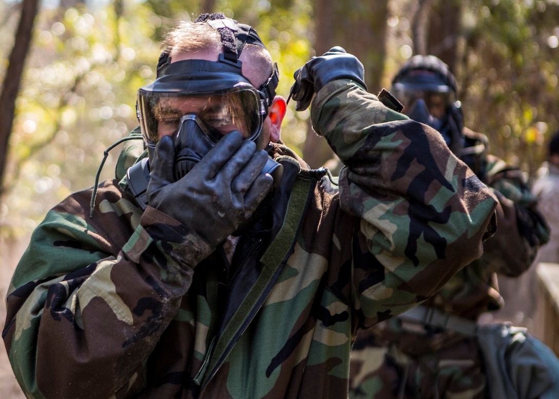 U.S. Marine Corps Capt. Jared Blake, 26th Marine Expeditionary Unit (MEU) communications officer, dons his gas mask during the 26th MEU's chemical biological radiological and nuclear (CBRN) defense training aboard Camp Lejeune, N.C., March 11, 2014. The training consisted of classroom instruction and an obstacle course to familiarize Marines with CBRN defense equipment and procedures. (U.S. Marine Corps photo by Lance Cpl. Joshua W. Brown/Released) 