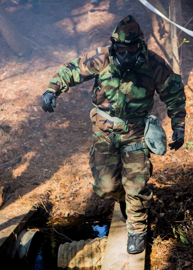 U.S. Marine Corps Master Gunnery Sgt. Jeffery Davis, 26th Marine Expeditionary Unit (MEU)  operations chief, traverses an obstacle during the 26th MEU's chemical biological radiological and nuclear (CBRN) defense training aboard Camp Lejeune, N.C., March 11, 2014. The training consisted of classroom instruction and an obstacle course to familiarize Marines with CBRN defense equipment and procedures. (U.S. Marine Corps photo by Lance Cpl. Joshua W. Brown/Released) 