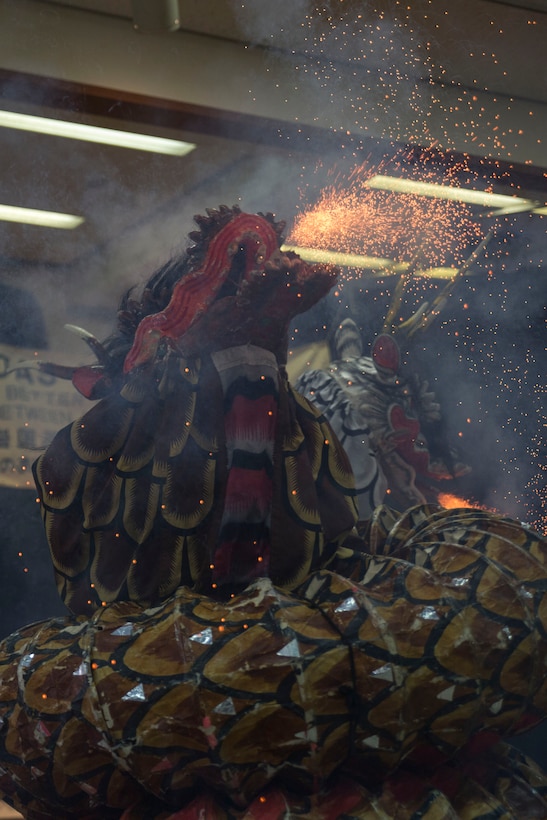 A member of the Fire Snake Theater, clad in a dragon costume, uses fireworks to portray the beast’s fire-breathing effect during the Kagura performance inside of the Matthew C. Perry High School cafeteria as part of the Japanese American Society Culture Festival, March 8, 2014 aboard, Marine Corps Air Station Iwakuni, Japan. Performers depicted the mythological tale of Yamata-no-Orochi, an eight-headed and eight-tailed serpent.