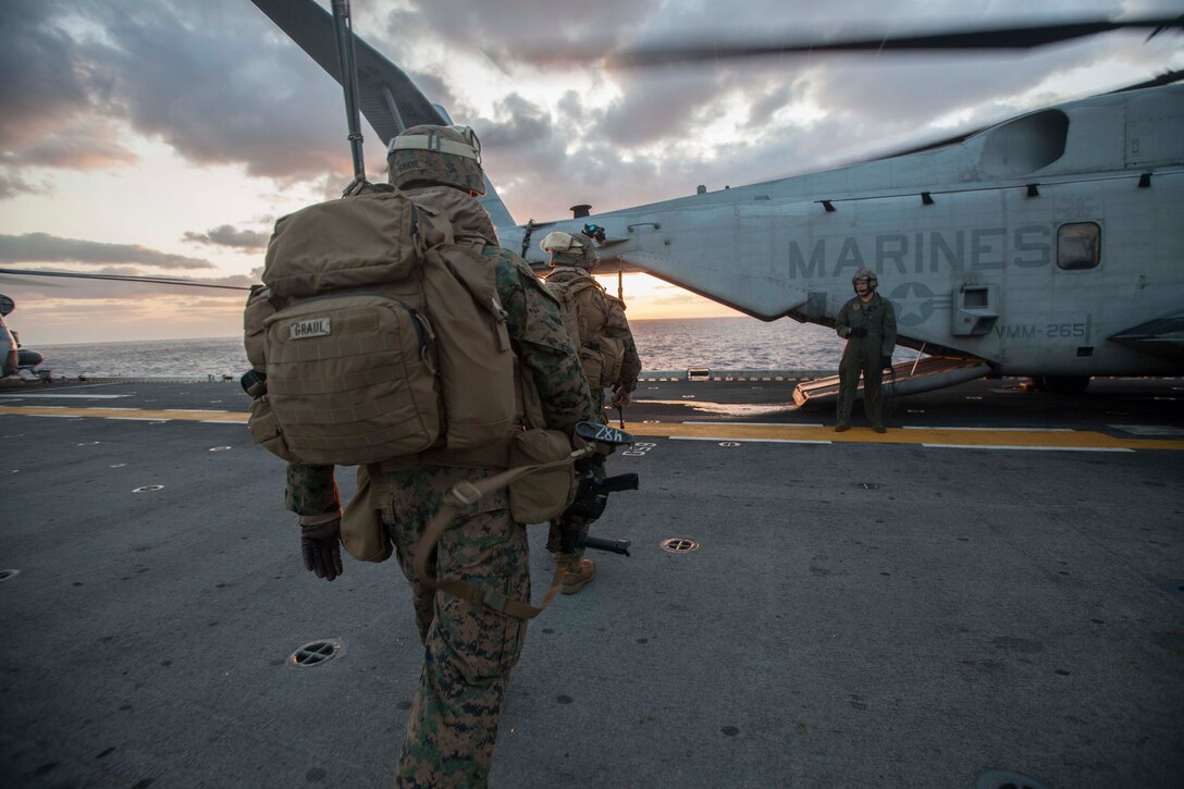 Marines and sailors with Company G, Battalion Landing Team 2nd Battalion, 5th Marine Regiment, 31st Marine Expeditionary Unit, board a CH-53E Super Stallion helicopter with Marine Medium Tiltrotor Squadron 265, 31st MEU, for a night raid on the flight deck of the USS Bonhomme Richard, Mar. 10. The raid force captured an airstrip and village from simulated enemy forces under the cover of darkness. The 31st MEU is currently conducting amphibious integration training alongside Amphibious Squadron 11 while deployed for its regularly scheduled Spring Patrol.