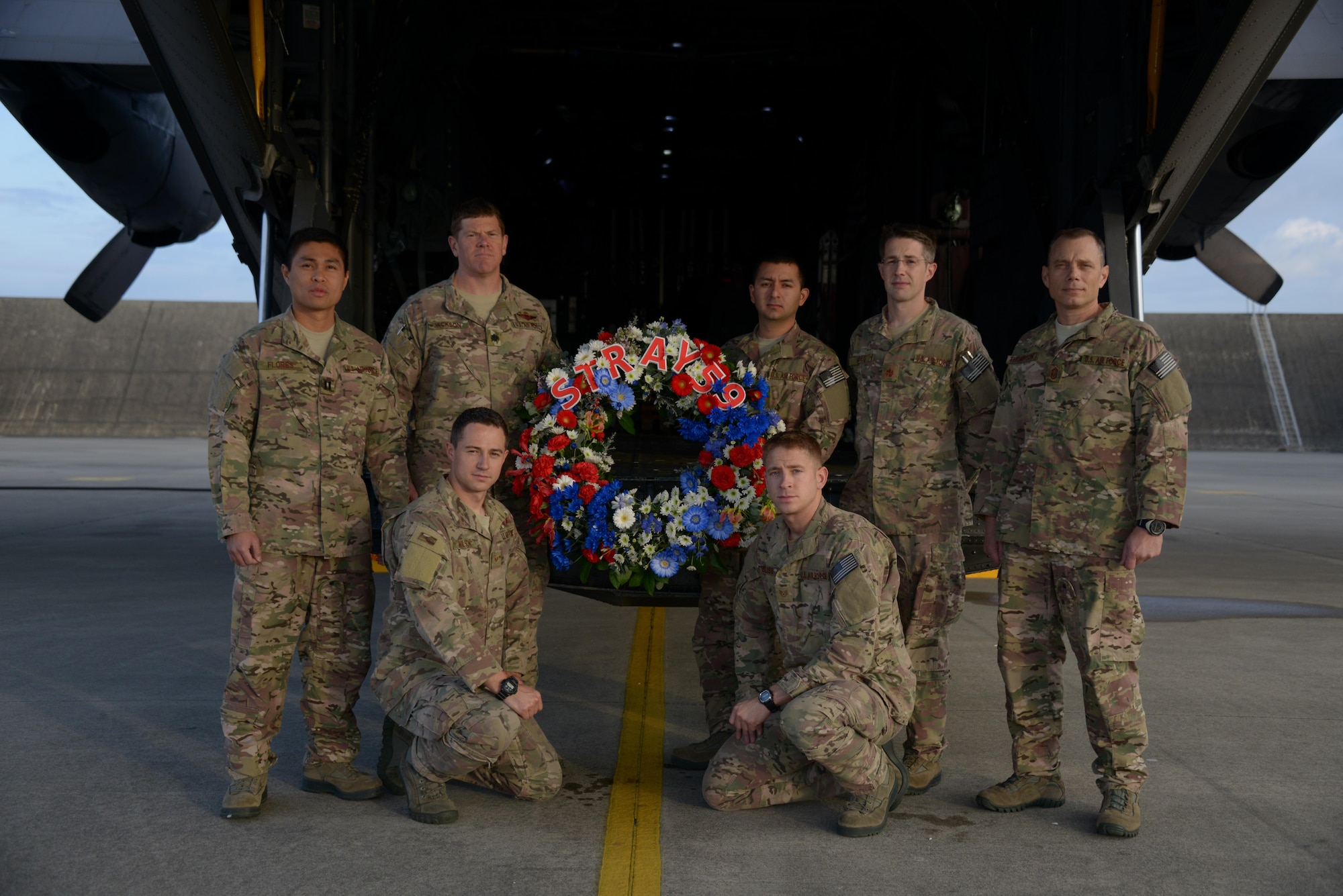 Members of the 1st Special Operations Squadron pose with a wreath that was dropped from a U.S. Air Force MC-130H Combat Talon II special operations aircraft to memorialize Stray 59 on Feb 26, 2013. Stray 59 was a 1st Special Operations Squadron U.S. Air Force MC-130E Combat Talon I special operations aircraft that crashed in 1981 near Subic Bay, Philippines, during a training mission. (U. S. Air Force photo by Tech. Sgt. Kristine Dreyer)