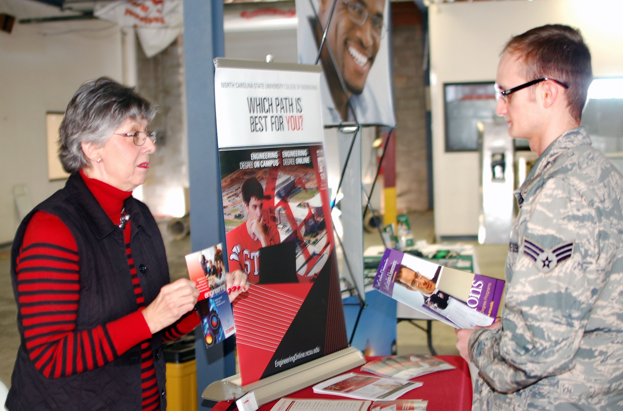 Linda Krute, admission counselor with North Carolina State University speaks with an airman from the North Carolina Air National Guard about the Master’s Degree program they offer.  Krute Baum came to take part in the college fair that has become a yearly event here at the North Carolina Air National Guard base, Charlotte Douglas Intl. airport, March 8, 2014. (U.S. Air National Guard photo by Staff Sgt. Alejandro M. Armendariz, 145th Public Affairs/Released)