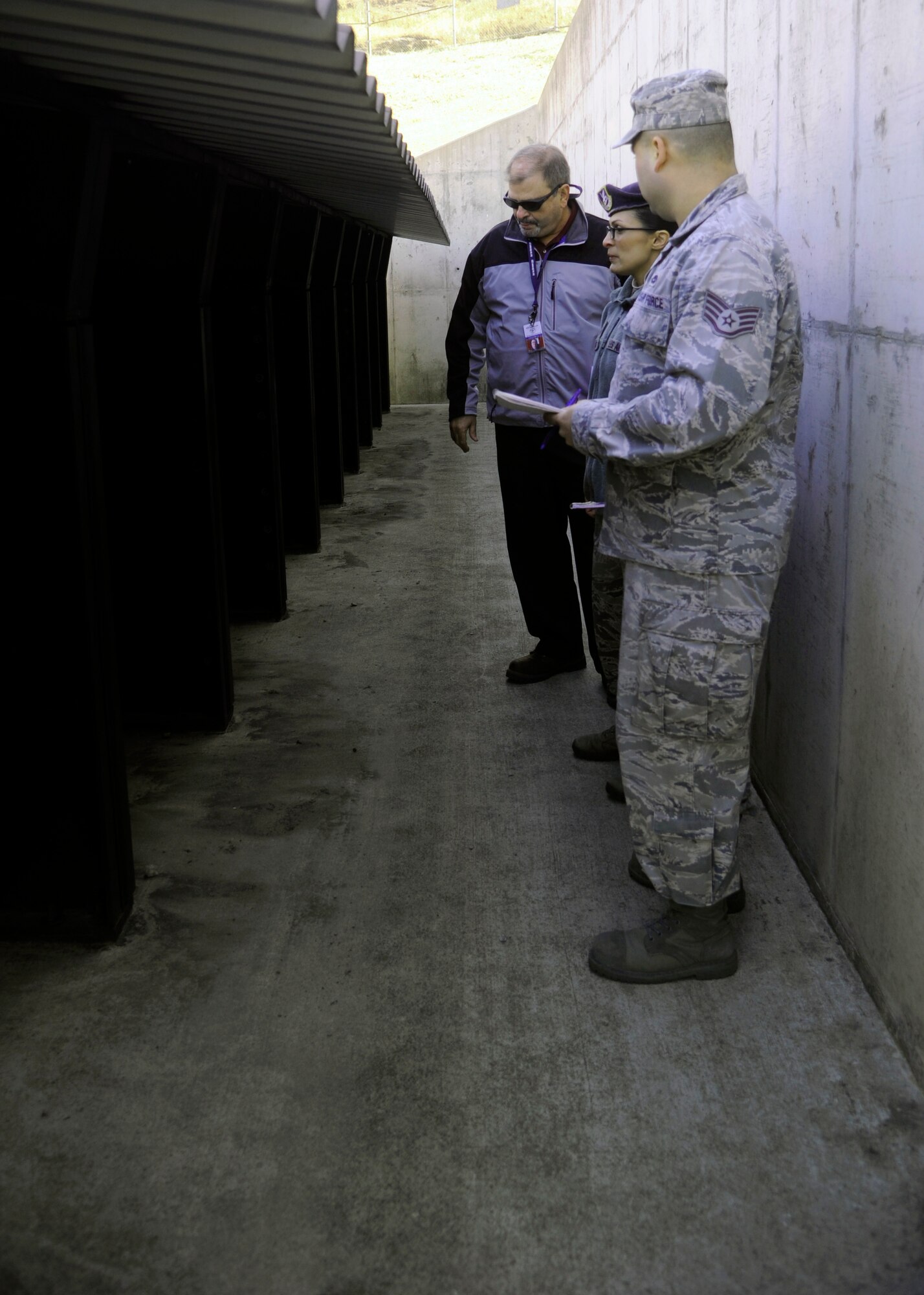 Lloyd Miller, Occupational Health Organization inspector, inspects the Combat Arms Training and Maintenance facility with Master Sgt. Yvonne Groves, 8th Security Forces Squadron flight chief, and Staff Sgt. Salvadore Gruny, 8th Medical Group bioenvironmental engineering technician, during a Unit Effectiveness Inspection at Kunsan Air Base, Republic of Korea, Mar. 5, 2014. This UEI was the first to be conducted in Pacific Air Forces and is the newest way of inspecting a base, which includes interviewing Airmen and inspecting critical areas of the base for effectiveness. (U.S. Air Force photo by Staff Sgt. Jessica Haas/Released)