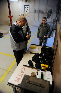 Lloyd Miller, Occupational Health Organization inspector, speaks with Master Sgt. Yvonne Groves, 8th Security Forces Squadron flight chief, and Staff Sgt. Salvadore Gruny, 8th Medical Group bioenvironmental engineering technician, about hearing safety used at the Combat Arms Training and Maintenance facility during a Unit Effectiveness Inspection at Kunsan Air Base, Republic of Korea, Mar. 5, 2014. This UEI was the first to be conducted in Pacific Air Forces and is the newest way of inspecting a base, which includes interviewing Airmen and inspecting critical areas of the base for effectiveness. (U.S. Air Force photo by Staff Sgt. Jessica Haas/Released)