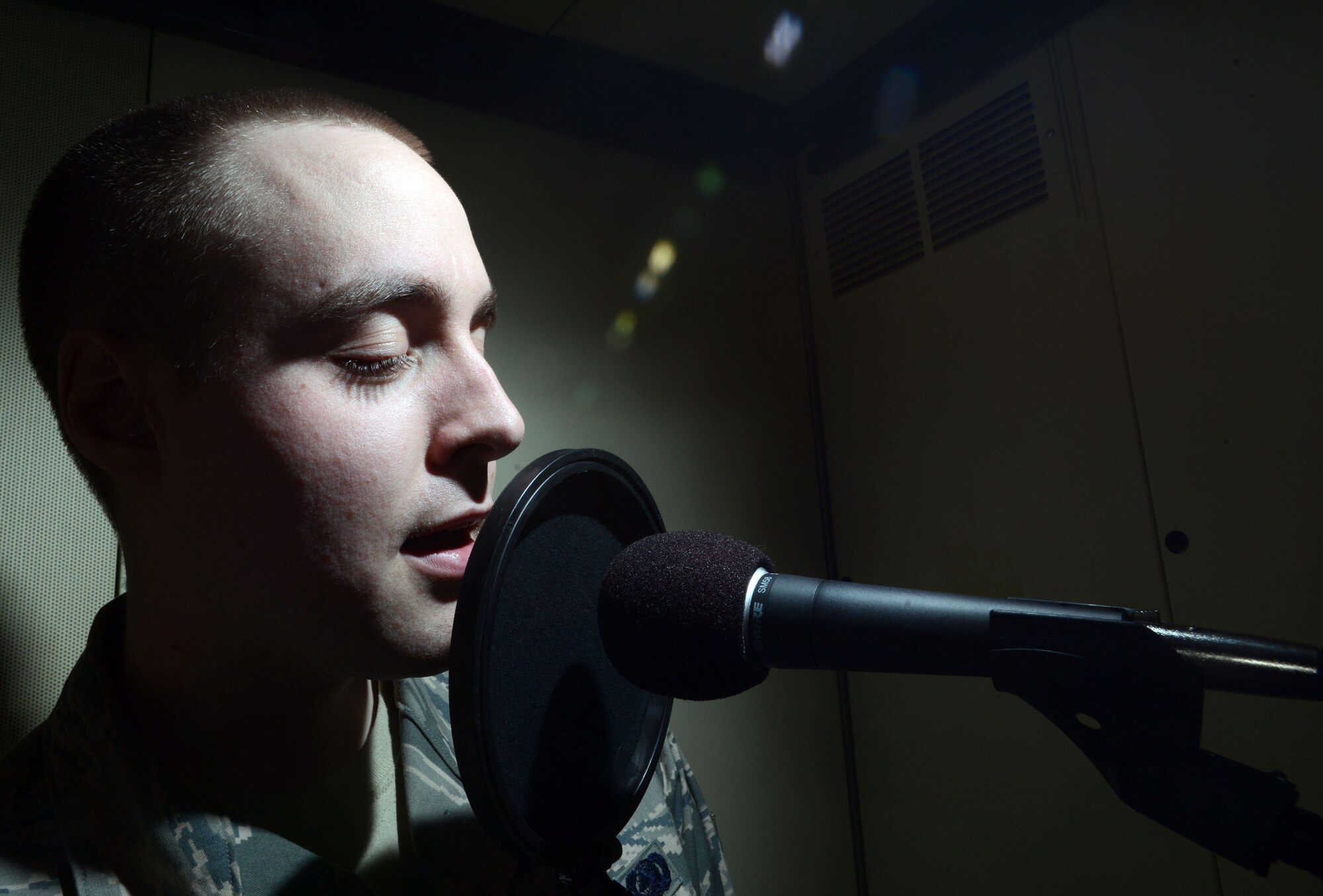 Airman 1st Class Alexander Ross, 673rd Logistic Readiness Squadron fuels technician, sings inside a sound booth at Joint Base Elmendorf-Richardson, Alaska, March 7, 2014. Ross was recently notified of his selection to be part of the 2014 Tops in Blue tour after only 11 months in the Air Force. (U.S. Air Force photo/Staff Sgt. Sheila deVera)


