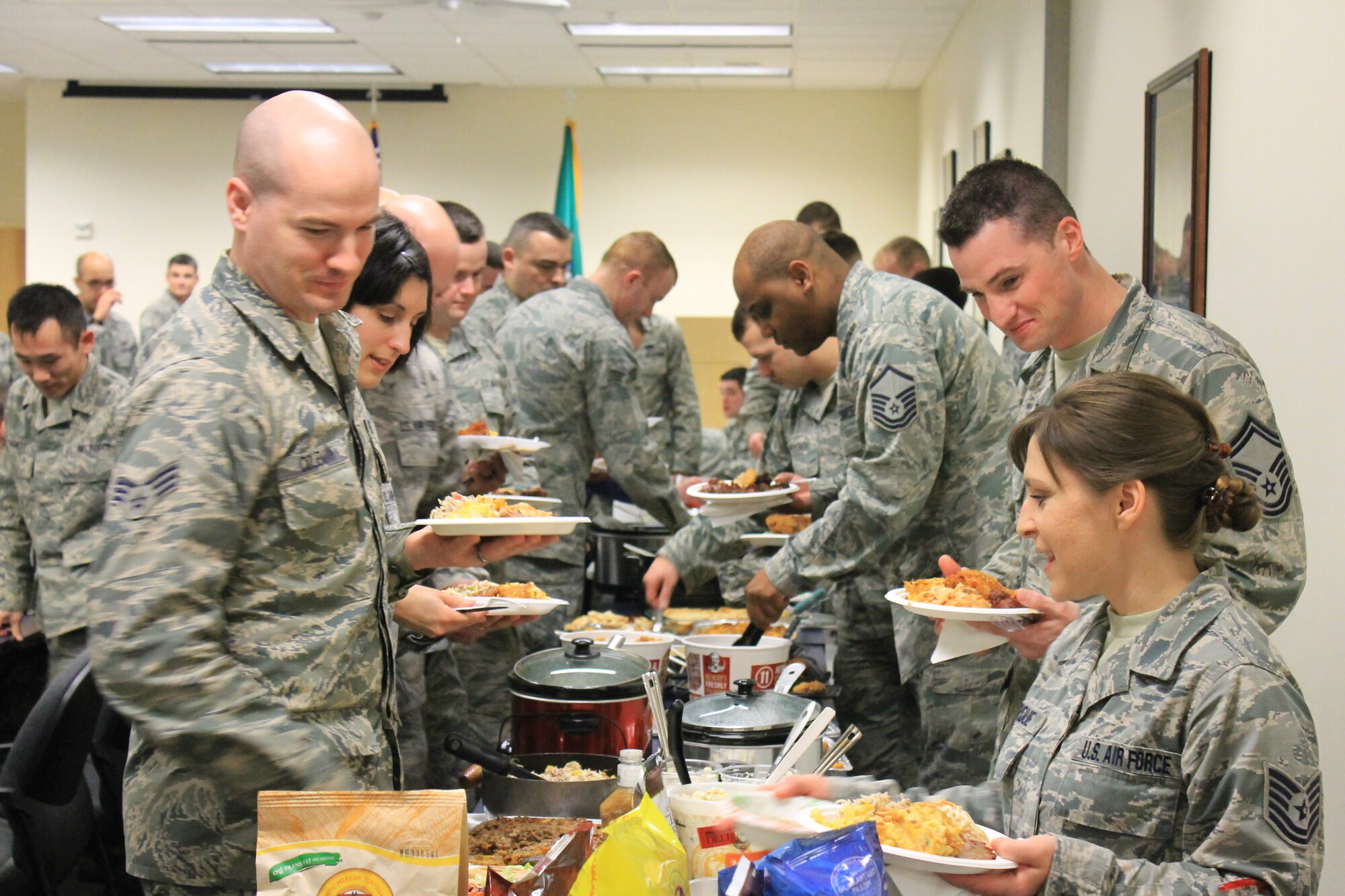 Members from the 92nd Logistics Readiness Squadron participate in a diversity pot luck during Wingman day March 7, 2014, at Fairchild Air Force Base, Wash. Fairchild AFB celebrates Wingman Day biannually to reinforce good Wingman behaviors and the four pillars of Comprehensive Airmen Fitness. (U.S. Air Force photo by Dawn Altmaier/Released)