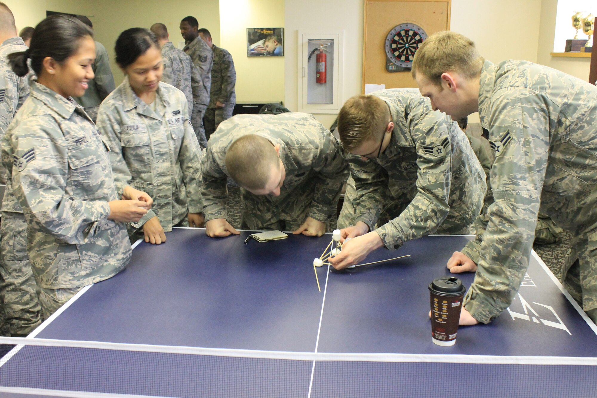 Members from the 92nd Communications Squadron build a marshmallow catapult as part of a team building activity during Wingman day March 7, 2014, at Fairchild Air Force Base, Wash. Fairchild AFB celebrates Wingman Day biannually to reinforce good Wingman behaviors and the four pillars of Comprehensive Airmen Fitness. (U.S. Air Force photo by Dawn Altmaier/Released)