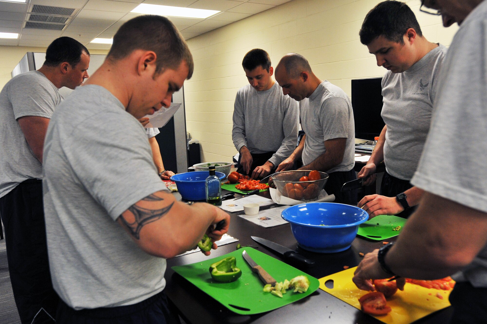Members from the 92nd Air Refueling Squadron make salsa at the Health and Wellness Center during Wingman day March 7, 2014, at Fairchild Air Force Base, Wash. Fairchild AFB celebrates Wingman Day biannually to reinforce good Wingman behaviors and the four pillars of Comprehensive Airmen Fitness. (U.S. Air Force photo by Staff Sgt. Veronica Montes/Released)