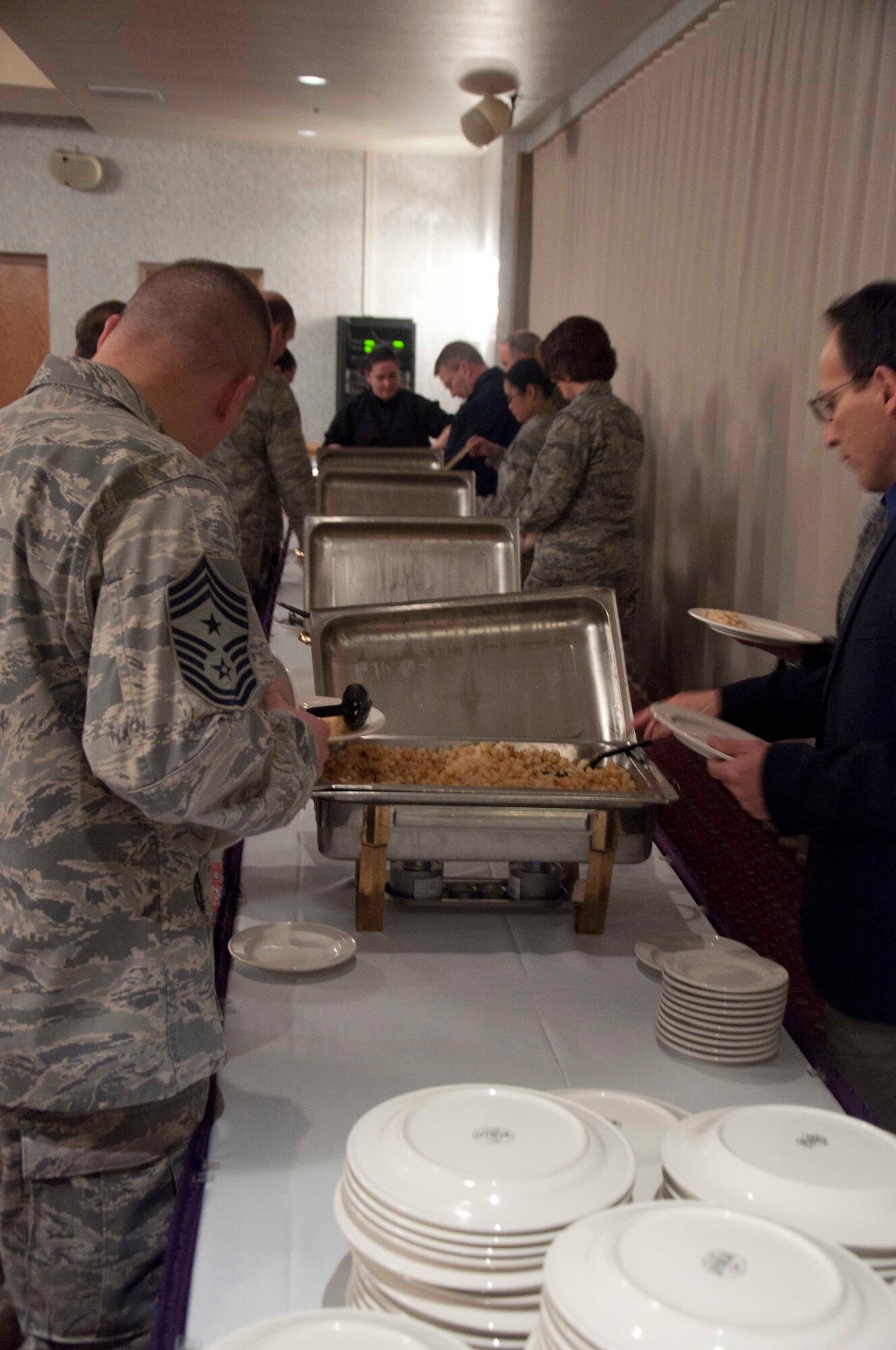 Airmen of the 90th Missile Wing serve themselves breakfast during a Sexual Assault Prevention and Response awareness event March 11 in the Trail’s End Club. Breakfast was followed by a presentation on sexual assault prevention by Anne Munch, a lawyer who specializes on SAPR programs for the Department of Defense. (U.S. Air Force photo by Airman 1st Class Brandon Valle)