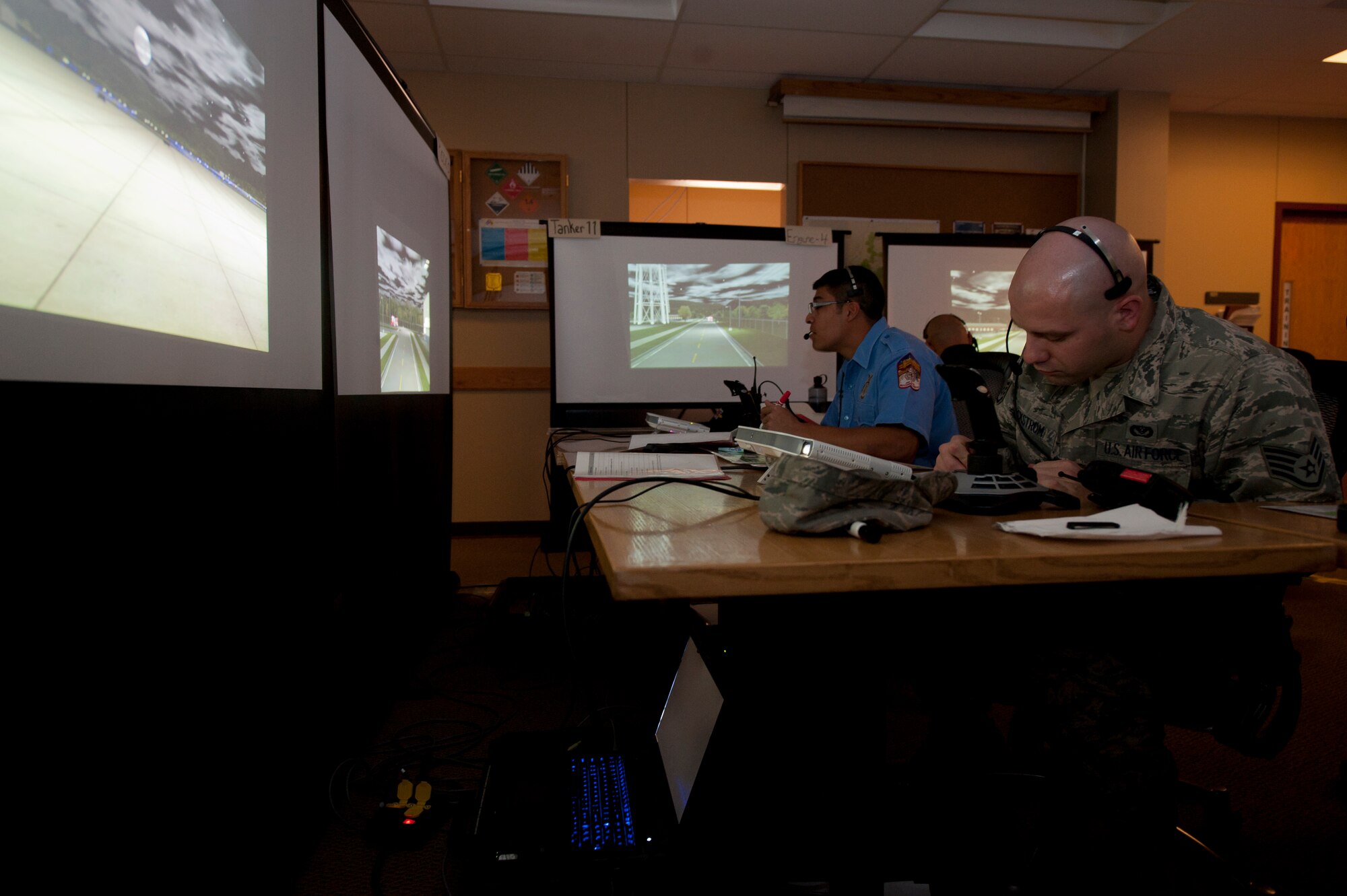 Eric Murillo, Fire Protection Engineer, and Staff Sgt. Jonathan Eckstrom, fire protection crew chief, prepare to practice emergency scenarios at Holloman Air Force Base, N.M., March 3. Holloman was host to the Department of Defense Fire Officer 2 certification course from the Louis F. Garland DoD Fire Academy at Goodfellow AFB, Texas. Fire Academy instructors from Goodfellow employed the new Advanced Disaster Management Simulator, an interactive video and computer training program allowing each firefighter to assume a higher amount of responsibility when responding to an incident.  (U.S. Air Force photo by Airman 1st Class Aaron Montoya / Released)
