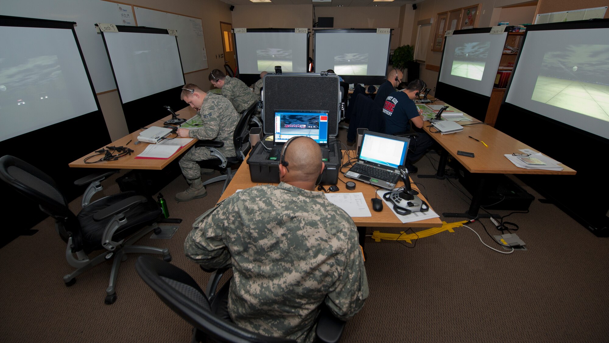 U.S. Army Sergeant 1st Class Brent Roberts, Department of Defense Fire Academy instructor, watches over a group of firefighters as they prepare to practice emergency scenarios at Holloman Air Force Base, N.M., March 3. Holloman was host to the Department of Defense Fire Officer 2 certification course from the Louis F. Garland DoD Fire Academy at Goodfellow AFB, Texas. Fire Academy instructors from Goodfellow employed the new Advanced Disaster Management Simulator, an interactive video and computer training program allowing each firefighter to assume a higher amount of responsibility when responding to an incident. (U.S. Air Force photo by Airman 1st Class Aaron Montoya / Released)