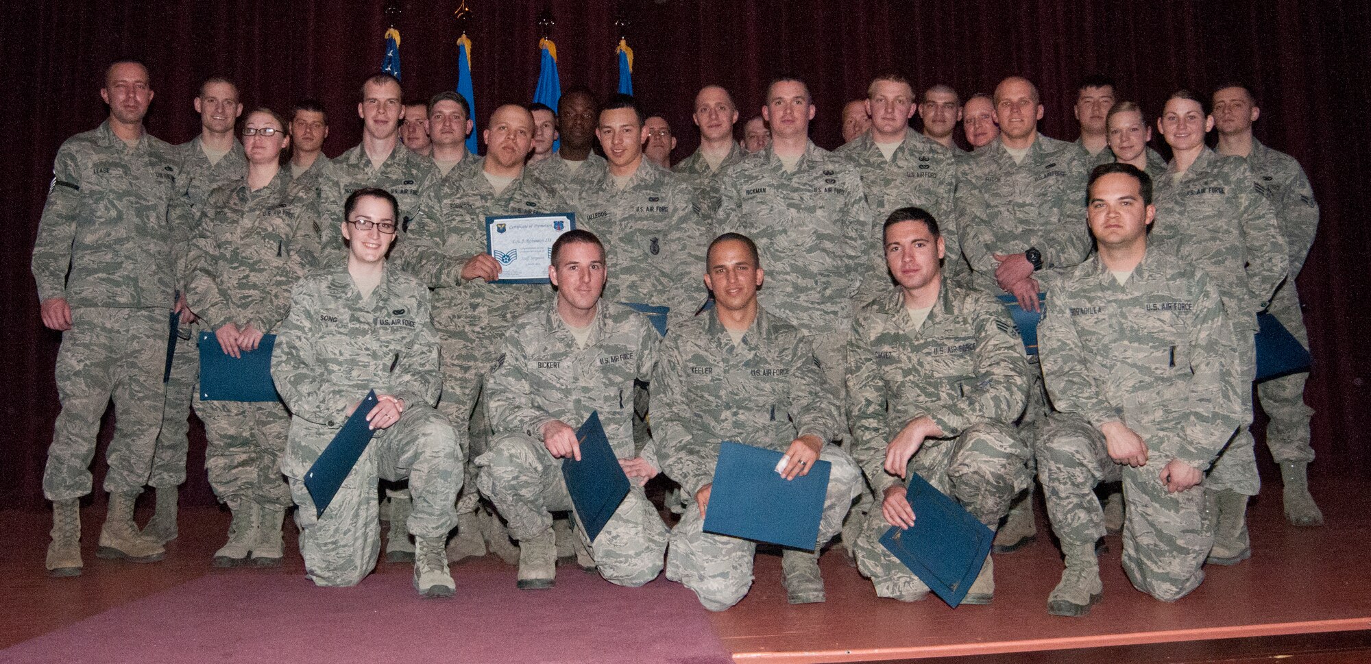 Enlisted 90th Missile Wing Airmen pose for a photo in the F.E. Warren Base Theater Feb. 28, 2014, during a congratulatory promotion ceremony for enlisted Airmen who advanced in rank in February or who would advance in rank the next day. (U.S. Air Force photo by Airman 1st Class Jason Wiese)
