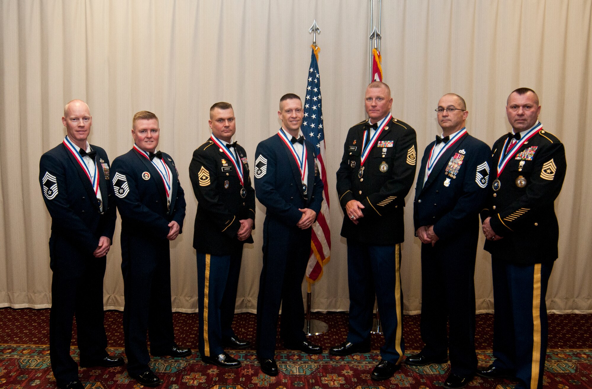 Newly promoted chief master sergeants and sergeants major in the Wyoming Air National Guard and National Guard pose during their recognition ceremony in the Trail’s End Club March 7, 2014. Chief master sergeant and sergeant major are the highest rank enlisted service members can attain in the Air Force and Army respectively. (U.S. Air Force photo by Airman 1st Class Jason Wiese)