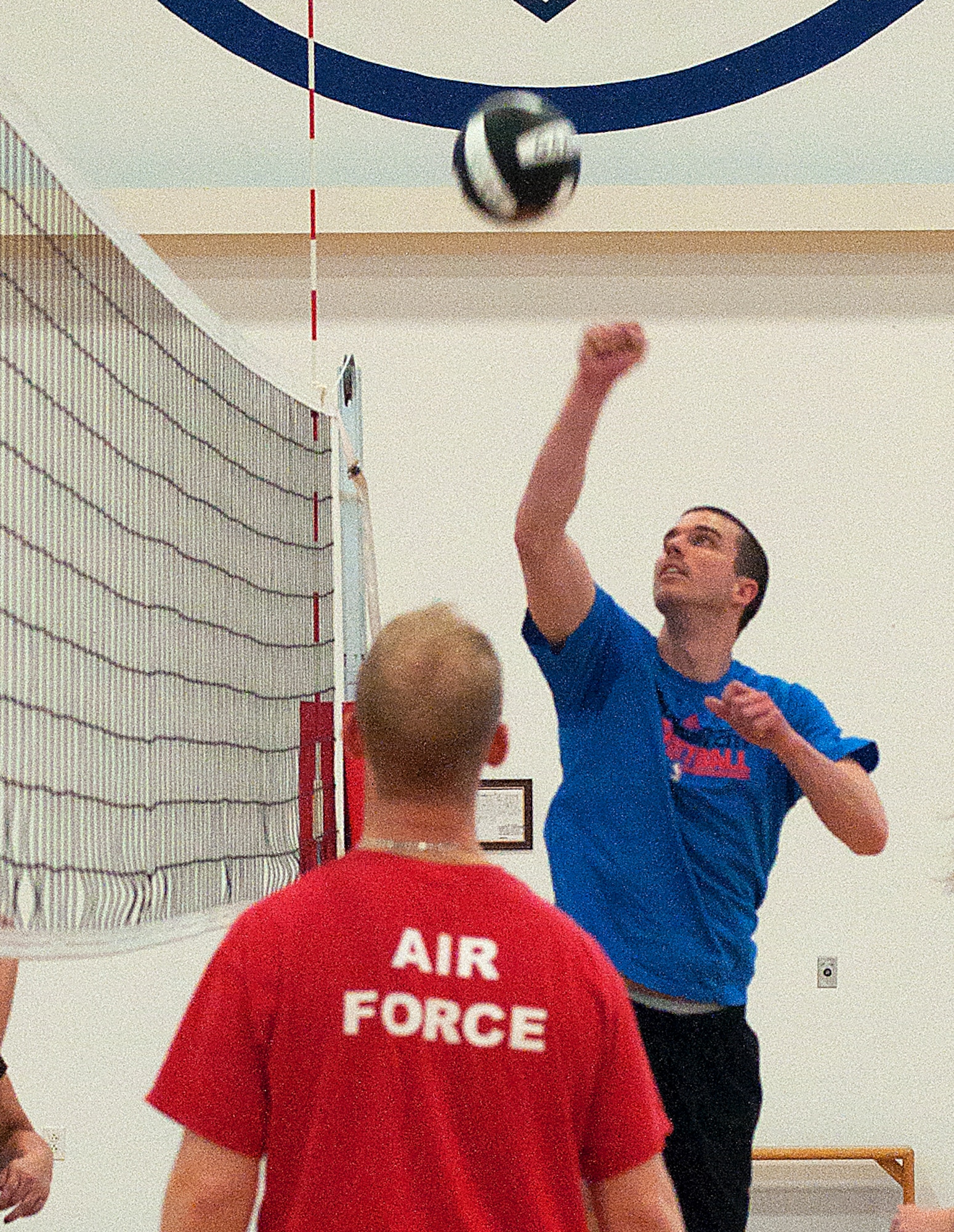 140311-F-GZ967-001 Second Lt. Joel Martin, 319th Missile Squadron deputy missile combat crew commander, leaps to return the ball to the opposing team March 11 in the Freedom Hall Fitness Center. (U.S. Air Force photo by Airman 1st Class Brandon Valle)