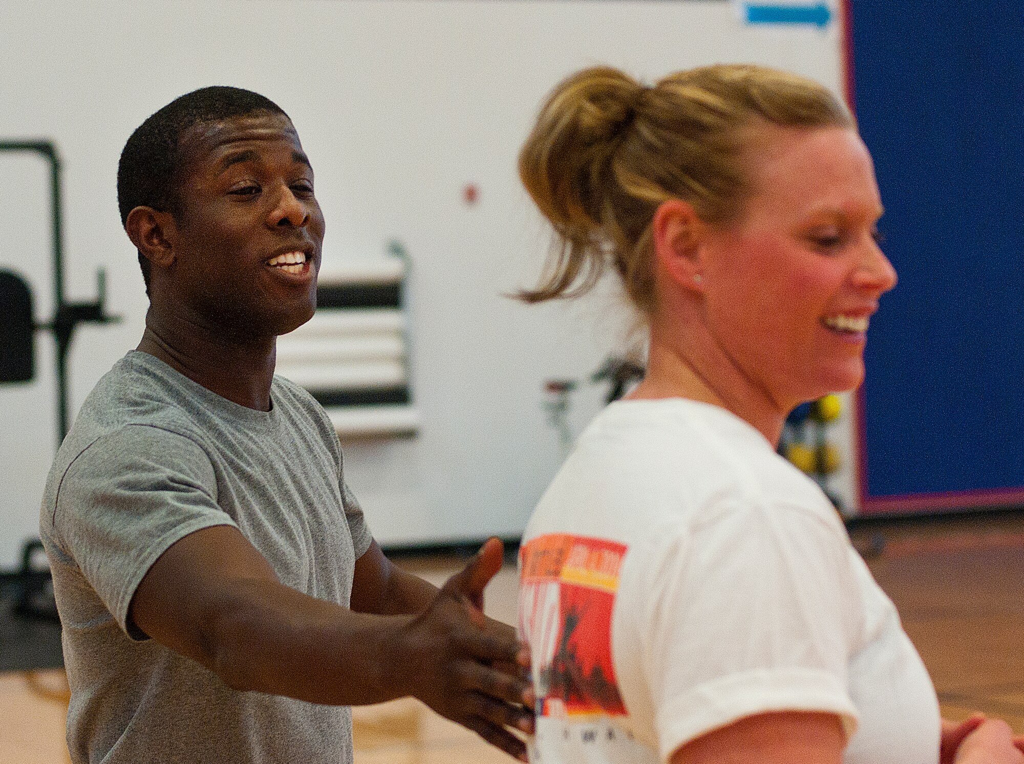 140311-F-CQ929-076 Airmen 1st Class Andrew Madden, 90th Comptroller Squadron customer service technician, gives support to Tech. Sergeant April Barnett, 90th Missile Command Post, March 11 in the Freedom Hall Fitness Center. (U.S. Air Force photo by Airman Malcolm Mayfield)