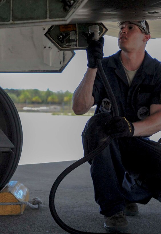 Senior Airman Trey MacLaughlin, a 525th Aircraft Maintenance Unit crew chief, services the oil on an F-22 Raptor engine during a thru flight inspection on the flightline at Joint Base Pearl Harbor-Hickam, Hawaii, March 11, 2014. The Raptors are on temporary duty to Hawaii for “Operation Cope Thaw” from the 525th Fighter Squadron at Elmendorf Air Force Base, Alaska. (U.S. Air Force photo/Tech. Sgt. Terri Paden)