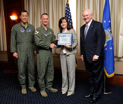 Ms. Pamela Rodriguez, second from the right, Financial Advisor, First Command, receives an honorary commander’s induction certificate from Col. Bill Knight, 11th Wing commander, and Mr. Jim Estepp, JBA senior honorary commander, right, during a ceremony on Joint Base Andrews, Md., March 7, 2014. Rodriquez is the honorary commander for the 1st Helicopter Squadron. She is joined by Col. Tim Buck, commander 1HS, far left. (U.S. Air Force photo/ Airman 1st Class Nesha Humes) 

