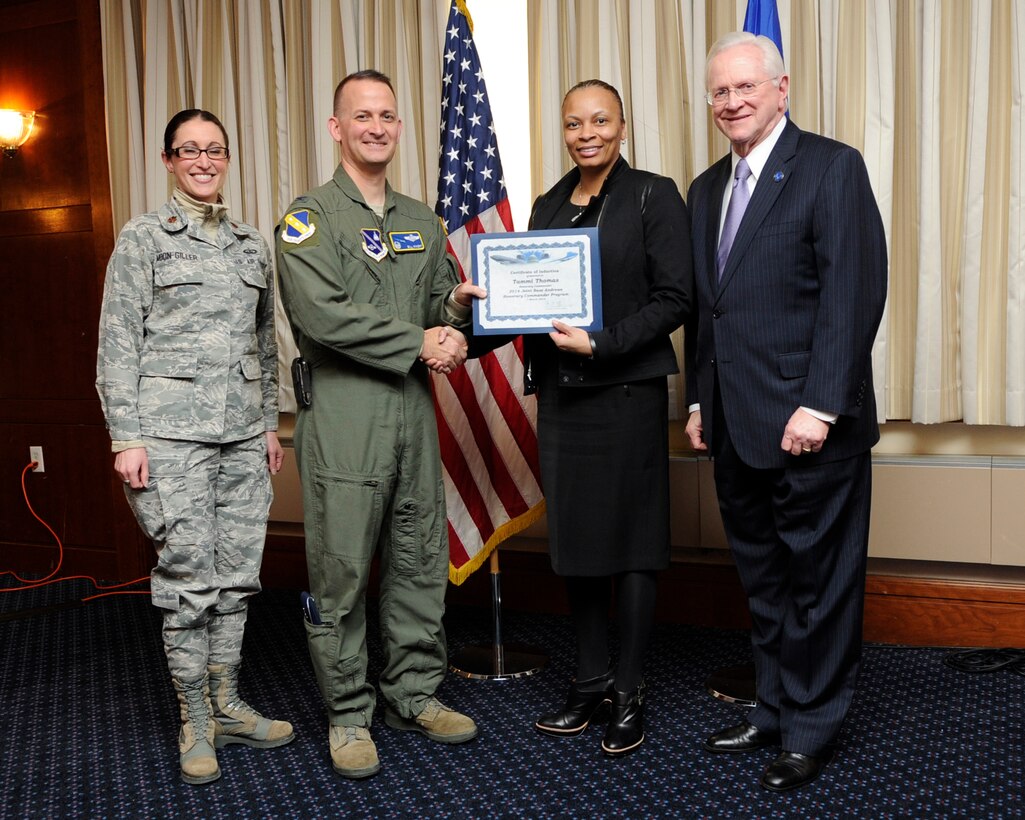 Ms. Tammi Thomas, second from the right, Chief of Staff to the President of Bowie State University, receives an honorary commander’s induction certificate from Col. Bill Knight, 11th Wing commander, and Mr. Jim Estepp, JBA senior honorary commander, far right, during a ceremony on Joint Base Andrews, Md., March 7, 2014. Thomas is the honorary commander for the 11th Force Support Squadron. She is joined by Maj. Kelli Moon, 11 FSS operations officer, far left. (U.S. Air Force photo/ Airman 1st Class Nesha Humes)