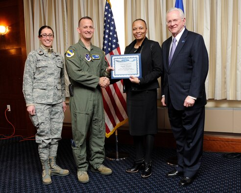 Ms. Tammi Thomas, second from the right, Chief of Staff to the President of Bowie State University, receives an honorary commander’s induction certificate from Col. Bill Knight, 11th Wing commander, and Mr. Jim Estepp, JBA senior honorary commander, far right, during a ceremony on Joint Base Andrews, Md., March 7, 2014. Thomas is the honorary commander for the 11th Force Support Squadron. She is joined by Maj. Kelli Moon, 11 FSS operations officer, far left. (U.S. Air Force photo/ Airman 1st Class Nesha Humes)