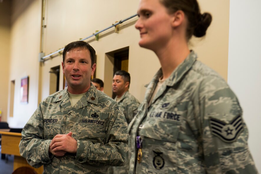 U.S. Air Force Maj. Jeffrey Spencer, 824th Base Defense Squadron commander, gives remarks during a Purple Heart Medal presentation ceremony for Staff Sgt. Haley Briggs, 824th BDS standards evaluation NCO in charge, March 12, 2014, at Moody Air Force Base, Ga. Spencer spoke on Briggs’ dedication to duty and her accomplishments thus far in her career, including making the rank of staff sergeant her first time testing and earning the John L. Levitow Award while attending Airman Leadership School last year. (U.S. Air Force photo by Staff Sgt. Jamal D. Sutter/Released) 