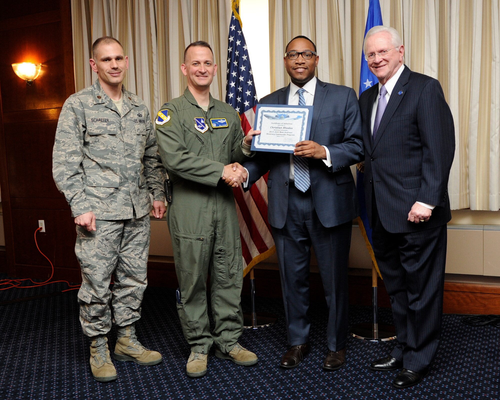 Mr. Christian Rhodes, second from the right, Education Advisor to Prince George’s County Executive, receives an honorary commanders induction certificate from Col. Bill Knight, 11th Wing commander, and Mr. Jim Estepp, JBA senior honorary commander, far right, during a ceremony on Joint Base Andrews, Md., March 7, 2014. Rhodes is the honorary commander for the 11th Comptroller Squadron. He is joined by Maj. Joseph Schaefer, 11 CPTS commander, far left. (U.S. Air Force photo/ Airman 1st Class Nesha Humes)