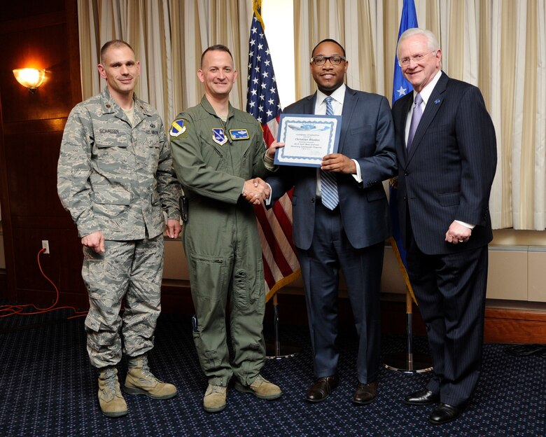 Mr. Christian Rhodes, second from the right, Education Advisor to Prince George’s County Executive, receives an honorary commanders induction certificate from Col. Bill Knight, 11th Wing commander, and Mr. Jim Estepp, JBA senior honorary commander, far right, during a ceremony on Joint Base Andrews, Md., March 7, 2014. Rhodes is the honorary commander for the 11th Comptroller Squadron. He is joined by Maj. Joseph Schaefer, 11 CPTS commander, far left. (U.S. Air Force photo/ Airman 1st Class Nesha Humes)