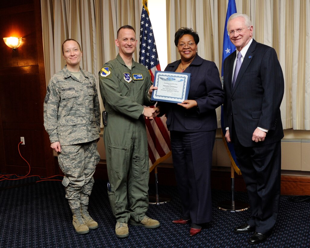 Ms. Pamela Creekmur, second from the right, Health Director Prince George’s County, receives an honorary commander’s induction certificate from Col. Bill Knight, 11th Wing commander, and Mr. Jim Estepp, JBA senior honorary commander, far right, during a ceremony on Joint Base Andrews, Md., March 7, 2014. Creekmur is the honorary commander for the 779th Aerospace Medical Squadron. She is joined by Chief Master Sgt. Michelle Thorsteinson-Richards, 79 Medical Wing Command Chief, far left. (U.S. Air Force photo/ Airman 1st Class Nesha Humes)