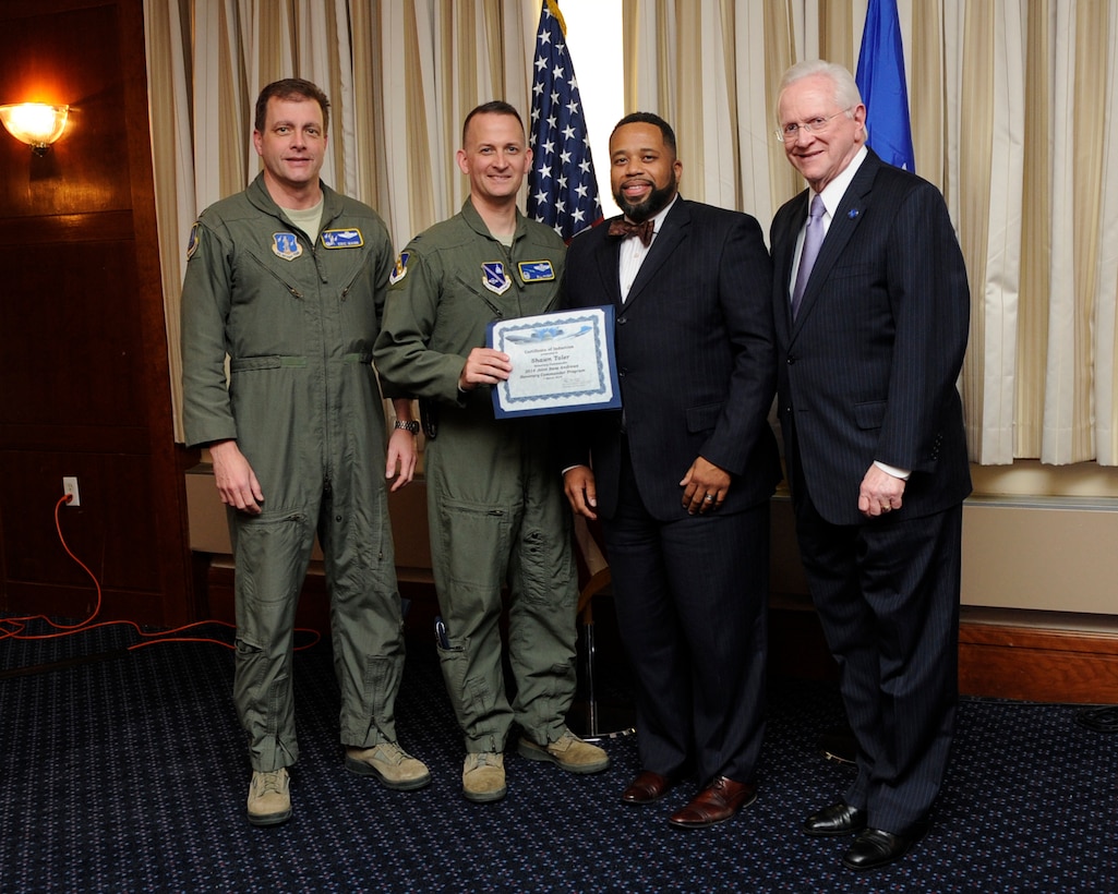 Mr. Shawn Toler, second from the right, regional director of Imagine Schools Maryland, receives an honorary commander’s induction certificate from Col. Bill Knight, 11th Wing commander, and Mr. Jim Estepp, JBA senior honorary commander, far right, during a ceremony on Joint Base Andrews, Md., March 7, 2014. Toler is the honorary commander for the Air National Guard Readiness Center. He is joined by Col. Eric Mann, far left, deputy commander ANGRC. (U.S. Air Force photo/ Airman 1st Class Nesha Humes)