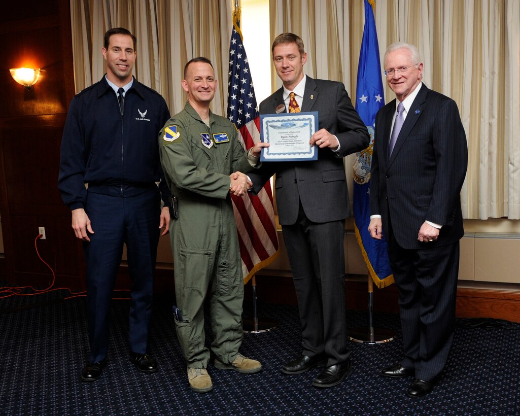 Mr. Ryan Patrylo, second from the right, owner of Chick-Fil-A, Brandywine, Md, receives an honorary commander’s induction certificate from Col. Bill Knight, 11th Wing commander and Mr. Jim Estepp, JBA senior honorary commander, right, during a ceremony on Joint Base Andrews, Md., March 7, 2014. Patrylo is the honorary commander for the 89th Maintenance Group. He is joined by Lt Col. Jason Bock, left, deputy commander 89 MXG, far left. (U.S. Air Force photo/ Airman 1st Class Nesha Humes)