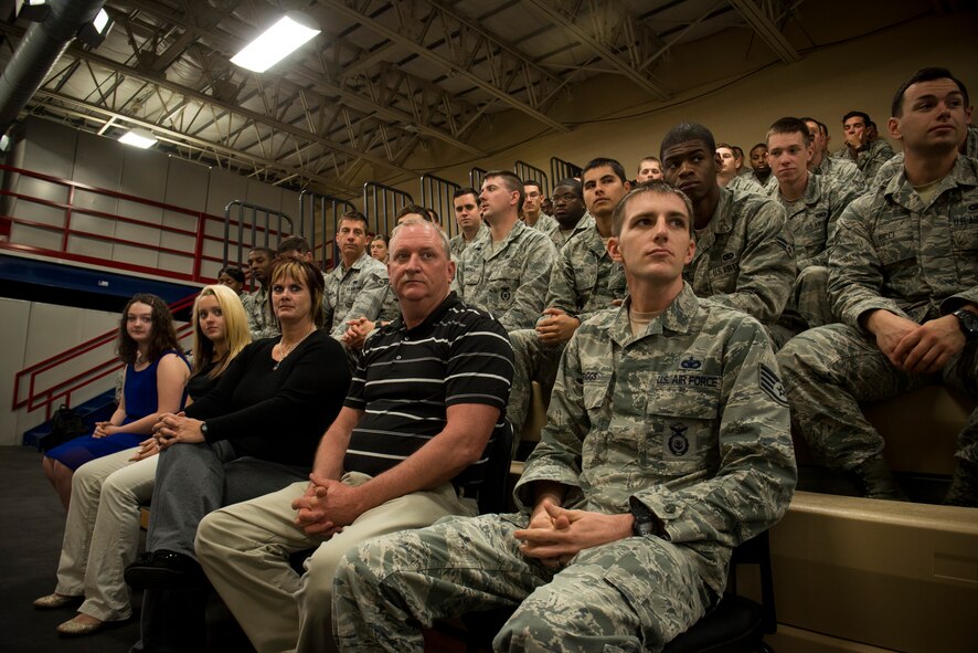 U.S. Air Force Staff Sgt. Daniel Briggs, 824th Base Defense Squadron fireteam leader, and his in-laws sit in attendance during a Purple Heart Medal presentation ceremony for Staff Sgt. Haley Briggs, 824th BDS standards evaluation NCO in charge, March 12, 2014, at Moody Air Force Base, Ga. Her father and mother, Gregory and Kay Adcock, and sisters, Christian Adcock and Katlyn Land, traveled from Social Circle, Ga., to share the moment with their loved one. (U.S. Air Force photo by Staff Sgt. Jamal D. Sutter/Released)  