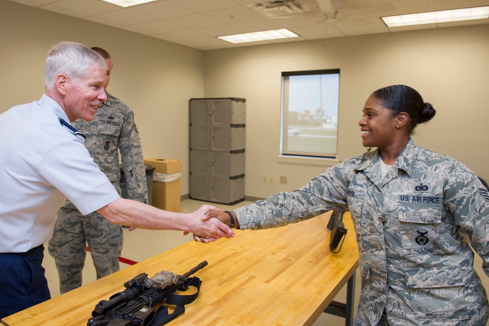 General William Shelton, commander, Air Force Space Command, spent two days this week talking to 45th Space Wing personnel, and visiting facilities at both Patrick Air Force Base and Cape Canaveral Air Force Station. Here, General Shelton shakes hands with Staff Sgt. Alexandria K. Brye, a 45th Space Wing Security Forces Airman who works in the Combat Arms Training and Maintenance shop. (U.S. Air Force photo/Matthew Jurgens). 