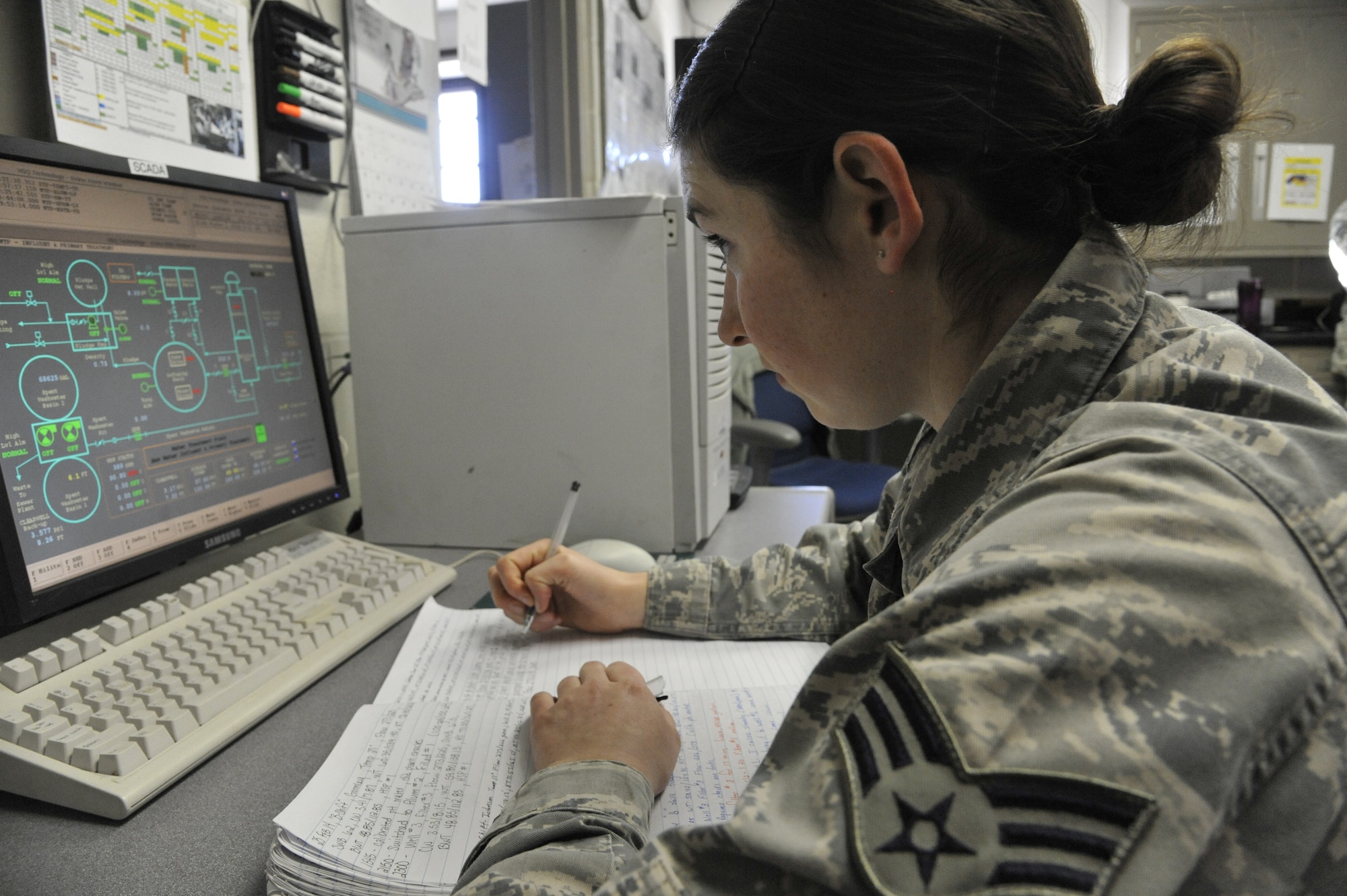 U.S. Air Force Senior Airman Jenifer Gormley, 509th Civil Engineer Squadron water and fuels maintenance journeyman, records information from the water plant monitoring computer at Whiteman Air Force Base, Mo., Feb. 27, 2014. This procedure monitors changes made throughout the day to the water system. (U.S. Air Force photo by Airman 1st Class Keenan Berry/ Released)
