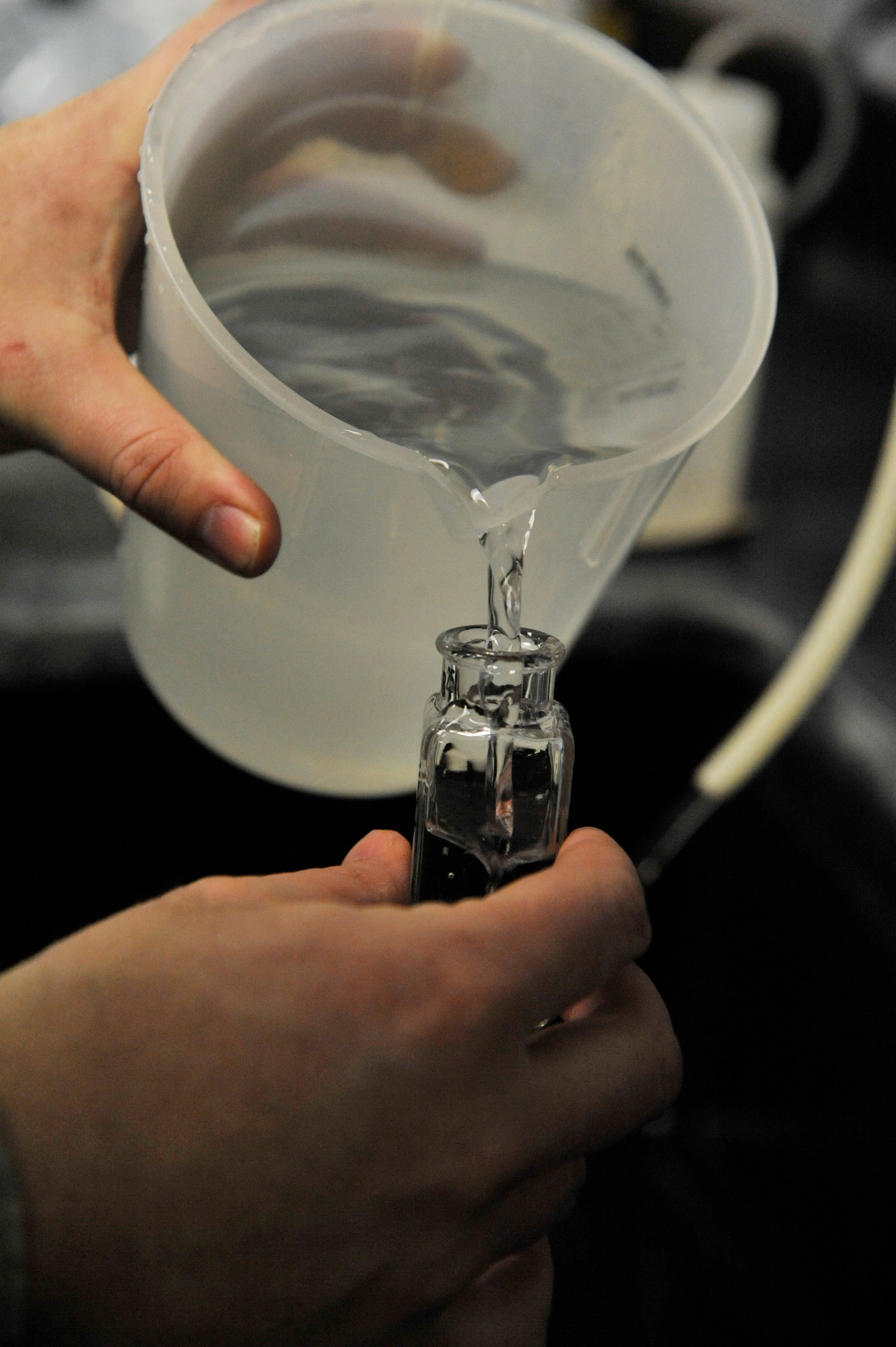 U.S. Air Force Senior Airman Jenifer Gormley, 509th Civil Engineer Squadron water and fuels maintenance journeyman, measures a water sample at Whiteman Air Force Base, Mo., March 3, 2014. The water plant team must ensure there is enough chlorine in the water to remove any harmful bacteria that may be present. (U.S. Air Force photo by Airman 1st Class Keenan Berry/Released)