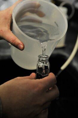 U.S. Air Force Senior Airman Jenifer Gormley, 509th Civil Engineer Squadron water and fuels maintenance journeyman, measures a water sample at Whiteman Air Force Base, Mo., March 3, 2014. The water plant team must ensure there is enough chlorine in the water to remove any harmful bacteria that may be present. (U.S. Air Force photo by Airman 1st Class Keenan Berry/Released)
