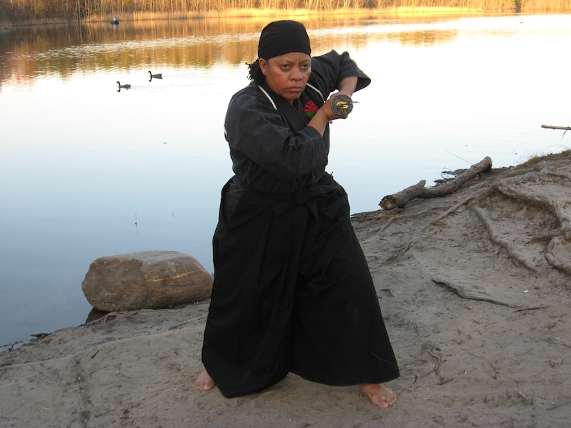 Tanya Jones, 514th Force Support Squadron human resources technician, demonstrates a Nisei Goju Ryu technique using a long sword called an Odachi at Pemberton Lake, NJ in 2012. Jones is a prominent figure within the competitive martial arts world holding a jaw-dropping line of accolades and accomplishments both locally and internationally. (Courtesy photo/Released)