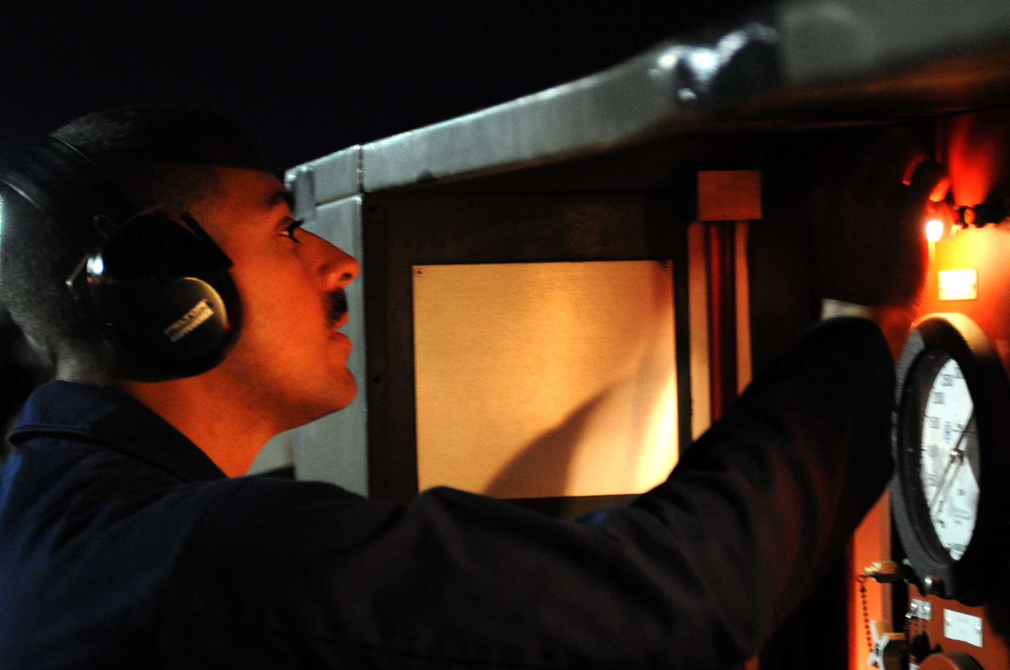 U.S. Air Force Staff Sgt. Jesuel Rosa Castillo, a 20th Aircraft Maintenance Squadron F-16 Fighting Falcon crew chief at Shaw Air Force Base, S.C., adjusts gauges during nighttime maintenance operations, March 11, 2014, at Nellis Air Force Base, Nev. Rosa Castillo and more than 100 other maintenance and support personnel participated in Red Flag 14-2 March 1-14. (Air Force photo/Staff Sgt. Chuck Broadway)
