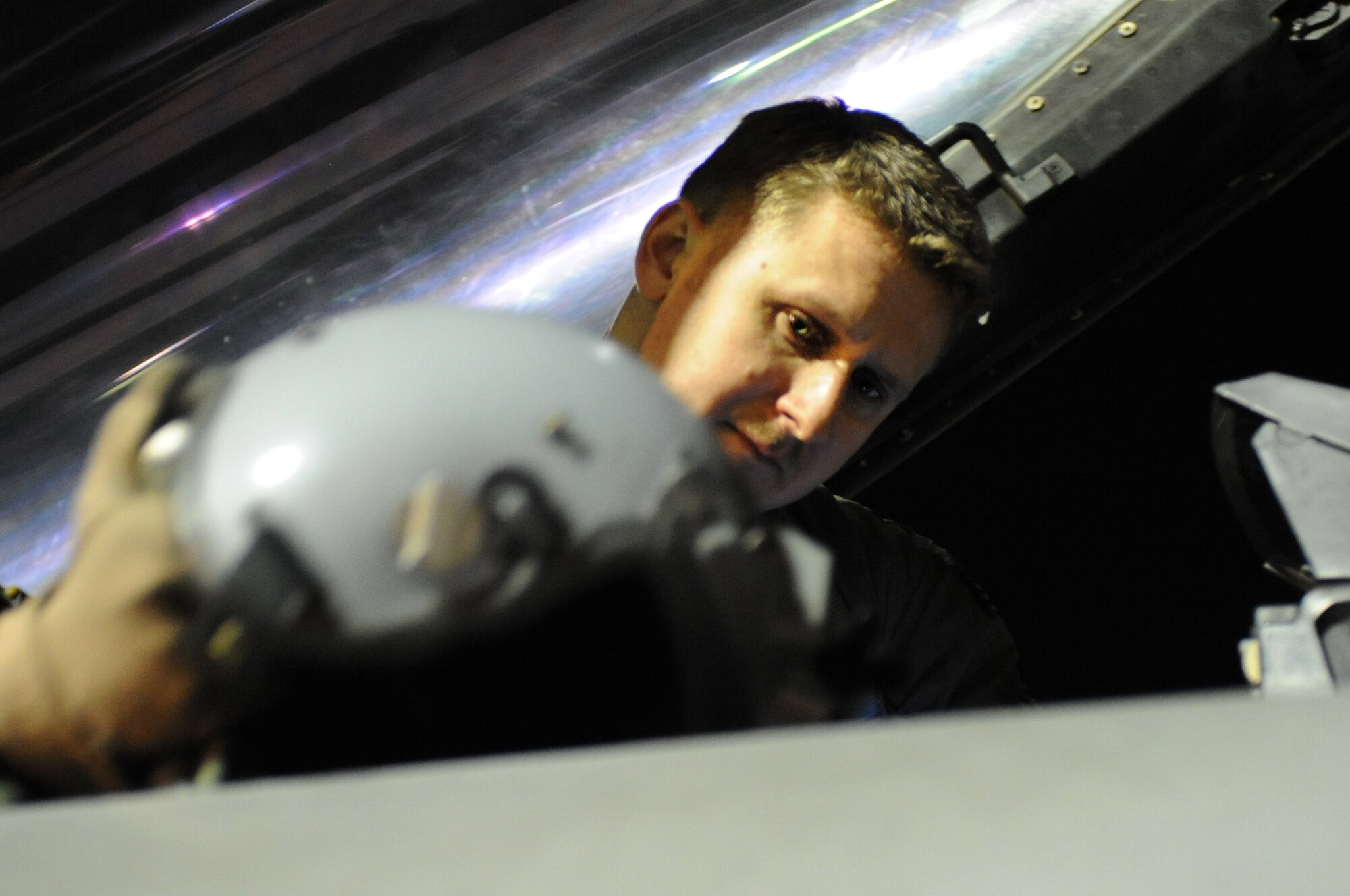 U.S. Air Force Capt. Jeremy Smallwood, a 77th Fighter Squadron F-16 Fighting Falcon pilot from Shaw Air Force Base, S.C., prepares his equipment prior to takeoff at Nellis Air Force Base, Nev., March 11, 2014. The 77th FS flew eight aircraft during night operations throughout Red Flag 14-2. (Air Force photo/Staff Sgt. Chuck Broadway)