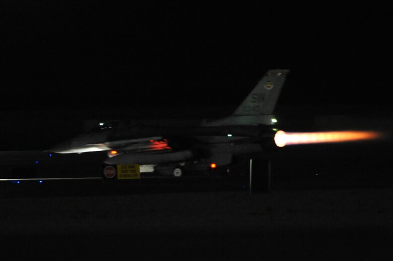 An F-16 Fighting Falcon from the 77th Fighter Squadron, Shaw Air Force Base, S.C., takes off from Nellis Air Force Base, Nev., during Red Flag 14-2 night operations March 10, 2014. Aircraft from multiple military units and coalition countries participated in the joint exercise which featured flying missions both day and night. (Air Force photo/Staff Sgt. Chuck Broadway)