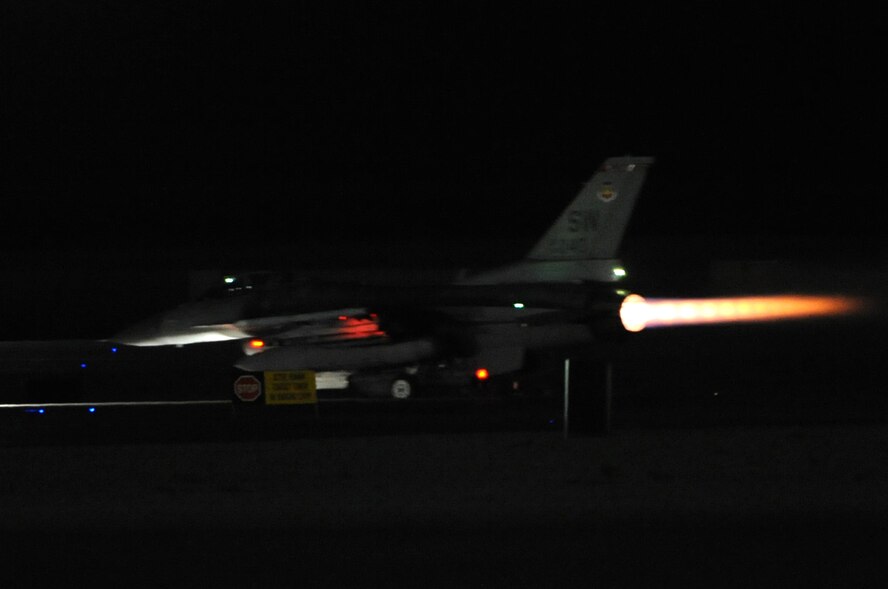 An F-16 Fighting Falcon from the 77th Fighter Squadron, Shaw Air Force Base, S.C., takes off from Nellis Air Force Base, Nev., during Red Flag 14-2 night operations March 10, 2014. Aircraft from multiple military units and coalition countries participated in the joint exercise which featured flying missions both day and night. (Air Force photo/Staff Sgt. Chuck Broadway)