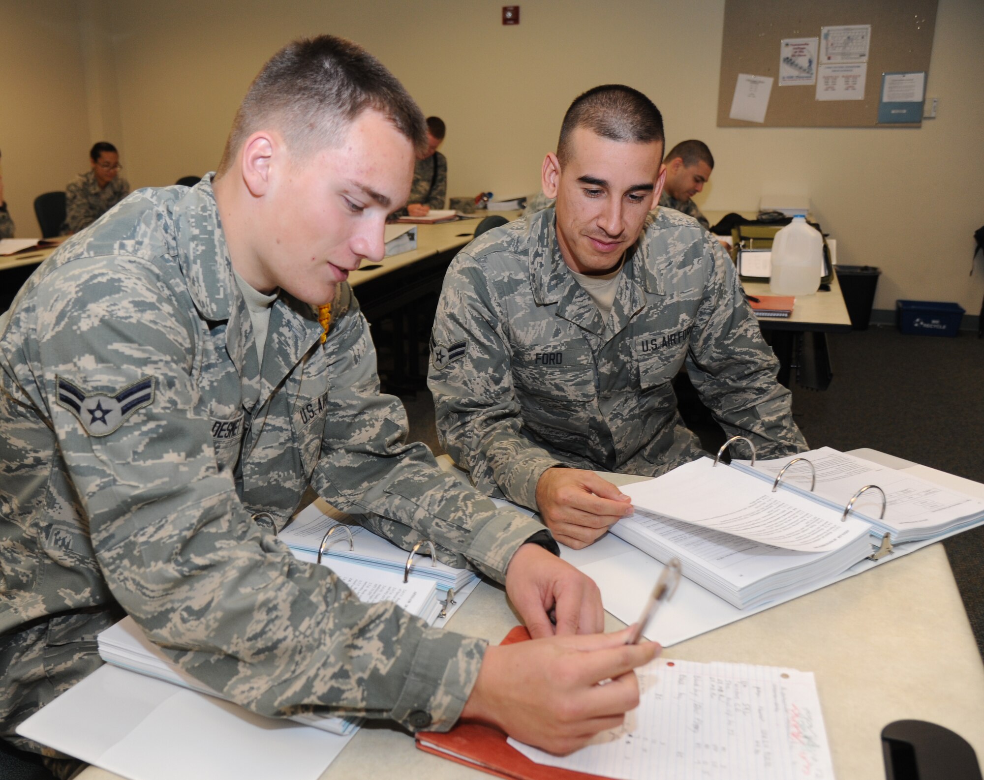 Airmen 1st Class Chance De Smet and Valentino Ford, 336th Training Squadron, review notes for their final exam in the cyber surety course March 11, 2014, at Thompson Hall, Keesler Air Force Base, Miss.  De Smet, from Kennewick, Wash., and Ford, from Tuson, Ariz., graduated with perfect scores and will remain at Keesler for further training. (U.S. Air Force photo by Kemberly Groue)