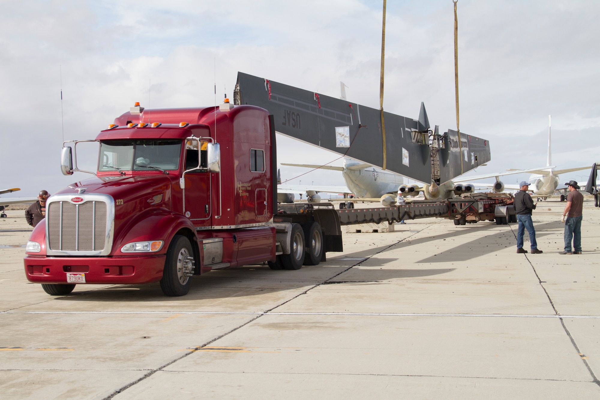 An Edwards RQ-4B Global Hawk Block 20 remotely piloted aircraft (tail number 2016) wing is loaded atop a specialized trailer that was capable of extending to 125 feet to accommodate the Global Hawk wing Mar. 1. The Global Hawk T/N 2016 will be transferred to the Persistent Maritime Unmanned Aircraft Systems Program Office (PMA-262) located at Naval Air Station Patuxent River, Md., to be used in MQ-4C Triton device development and maintenance training. (U.S. Air Force photo by Brad White)