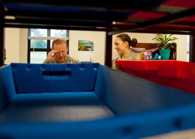 Airman 1st Class Jennie Short, 628th Communications Squadron official mail center, sorts mail with Col. Jeffery DeVore, Joint Base Charleston commander during a 628th Air Base Wing leadership visit to the OMC March 7, 2014. 
Each month DeVore and his staff visit a different 628th agency and receive a hands-on tutorial on how to do a specific job. As mail room staff, Devore, Chief Master Sgt. Mark Bronson, 628th ABW command chief and Master Chief Petty Officer Joseph Gardner, Naval Support Activity Command Master Chief, learned to pitch, sort and deliver mail, metered and stamped. (U.S. Air Force photo/Staff Sgt. William A. O’Brien)

